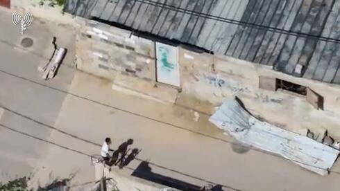 IDF posts video of Gaza terrorist using child to move weapons