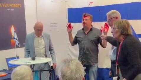 Man arrested after spraying red paint on Israeli flag at Sweden book fair | Watch